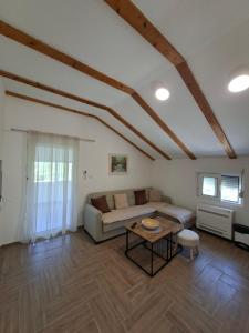 a living room with a couch and a table at Apartmani Suvodoli in Rvaši