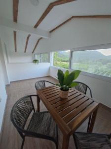a dining room with a wooden table and chairs at Apartmani Suvodoli in Rvaši