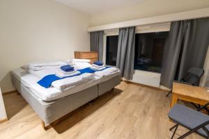 a bedroom with a bed with two towels on it at Øksfjord Hotel Norway in Øksfjord +37 photos
