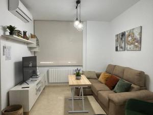 a living room with a couch and a table at Casa Yaye Ecija in Écija
