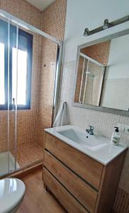 a bathroom with a sink and a shower at Casa Yaye Puerta Palma in Écija +54 photos