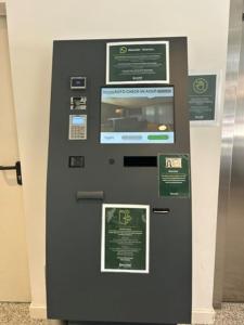 a black ticket machine with signs on it at Sercotel Logroño Suites in Logroño