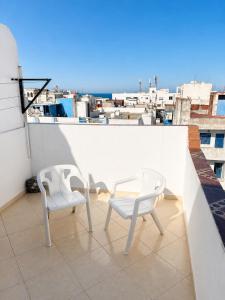 two white chairs sitting on a balcony with a view at STUDIO FOR 3 PERSON & ANOTHER FOR 4 PERSON - MIRAMAR MARTIL ll in Martil