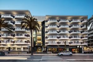 a building with a car parked in front of it at AQUA Hotel Promenade & Spa 4Sup in Pineda de Mar