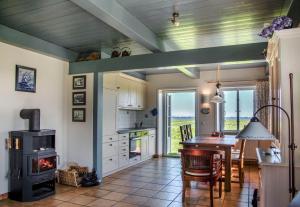 a kitchen with a table and a stove at Reethuus am Fething in Langeneß