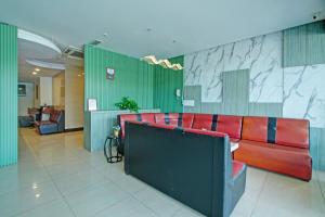 a lobby with a red couch in a building at Collection O Near Tanjung Batu Formerly 4orty Inn in Bintulu