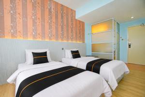 two beds in a hotel room with two at Collection O Near Tanjung Batu Formerly 4orty Inn in Bintulu +39 photos