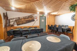 a room with rows of chairs and tables in it at Øksfjord Hotel Norway in Øksfjord