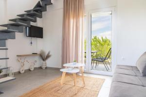 a living room with a couch and a table at Viento Suites Possidi in Possidi