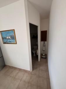 a hallway with a toilet and a painting on a wall at Casa Lia in Ortiporio