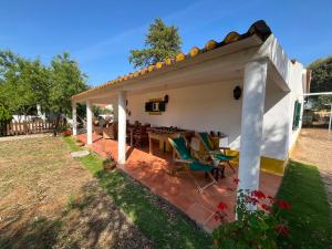 a house with a patio with a table and chairs at Courela da Anta in Vimieiro
