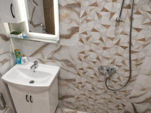 a bathroom with a white sink and a shower at Apartment Be Happy 6, Premium Apartment in Ruse City Centre in Ruse