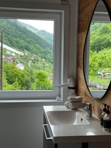 a bathroom with a sink and a large window at Fjord House Hardanger in Grimo