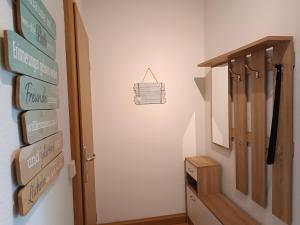 a hallway with signs on the wall next to a door at Ferienwohnung Karl 54 in Gelenau