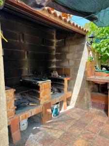 an outdoor brick oven in the side of a house at Mas de Manresa in Horta de San Joan