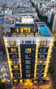 a building with a swimming pool and lights on it at VISION Omonia Athens in Athens