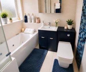 a bathroom with a tub and a toilet and a sink at Bliss Home in Harrow on the Hill +11 photos