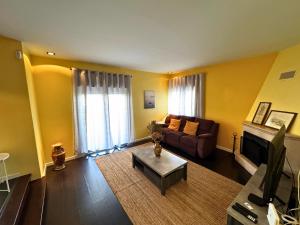 a living room with a couch and a table at Cascais House - Pool in Parede