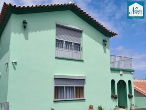 a white and green house with a red roof at Nandes Place in Praia da Vitória