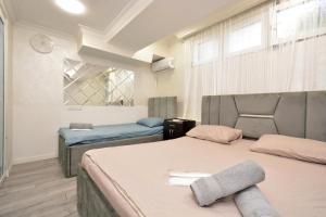 a bedroom with two beds and a window at Old Yerevan Guesthouses in Yerevan