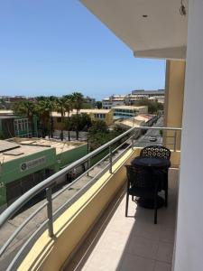 a balcony with a table and a view of a street at Apartamentos Santiago - Praia in Praia