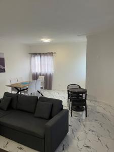 a living room with a couch and a table at Apartamentos Santiago - Praia in Praia