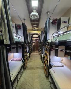 a room with several bunk beds in a bus at AV Dormitory in Rourkela