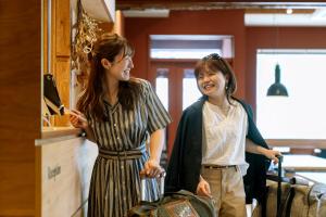 two women standing next to each other at B and D HAKUBA IWATAKE in Hakuba