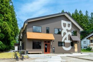 a building with a sign on the side of it at B and D HAKUBA IWATAKE in Hakuba
