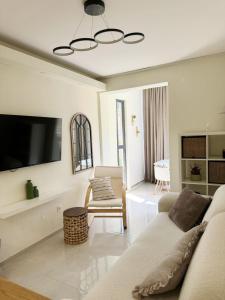 a living room with a couch and a flat screen tv at Central Prestige Apartment in Budva