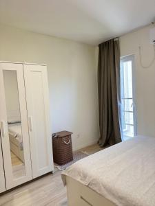 a bedroom with a bed and a large mirror at Central Prestige Apartment in Budva