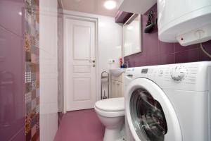 a bathroom with a toilet and a washing machine at Old Yerevan Guesthouses in Yerevan +39 photos