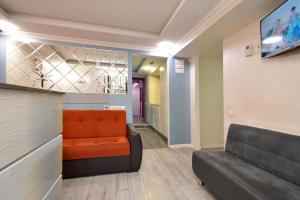 a waiting room with a couch and a television at Old Yerevan Guesthouses in Yerevan