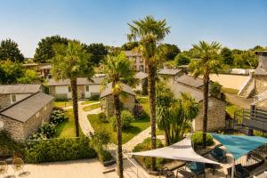 an aerial view of a resort with palm trees at Les Treize Assiettes - Baie du Mont-Saint-Michel in Le Val-Saint-Père