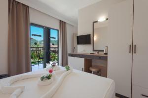 a hotel room with a bed and a desk and a window at 7 Brothers Hotels in Marmaris