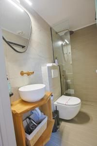 a bathroom with a sink and a toilet at Makaros Nissos City in Mytilene +11 photos