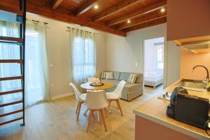 a kitchen and living room with a table and chairs at Makaros Nissos City in Mytilene