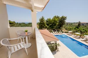 a view from the balcony of a villa with a swimming pool at Noma Vasilikos in Vasilikos