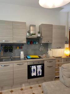 a kitchen with a sink and a stove top oven at villa martina suite apartament in Lacco Ameno