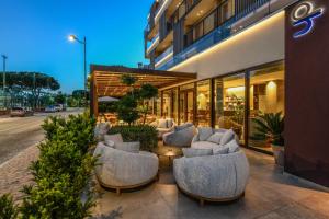 a group of chairs sitting outside of a building at Petit Hotel in Caorle