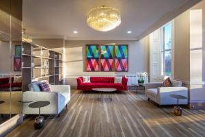 a living room with two couches and a red couch at JA The Bruntsfield - Edinburgh in Edinburgh