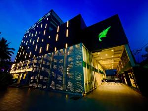 a building with a green sign on the side of it at The Fern Residency Bengaluru, Yeshwanthpur, Series by Marriott in Bangalore