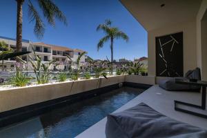 a swimming pool in the middle of a house at La Finestra in Nydri