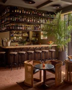 a bar with chairs and a table in a room at Hotel Anna & Bel in Philadelphia