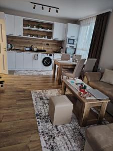 a living room with a couch and a table at Апартамент Четири сезона 2 in Velingrad