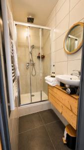 a bathroom with a shower and a sink at Logicoeur in Gérardmer