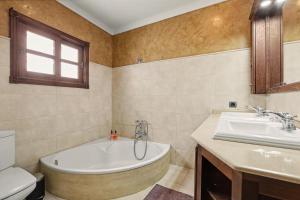 a bathroom with a tub and a sink at Rincón de Daute in Los Silos +25 photos