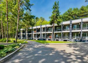 an exterior view of a building with trees at Sosnovel in Voropayev