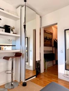 a living room with a mirror and a stool at Mini Apartment in Öhningen +22 photos