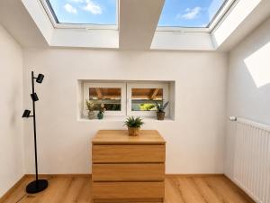 a skylight in a room with a wooden dresser at Alpzeit Ferienwohnung in Bayerisch Gmain +15 photos